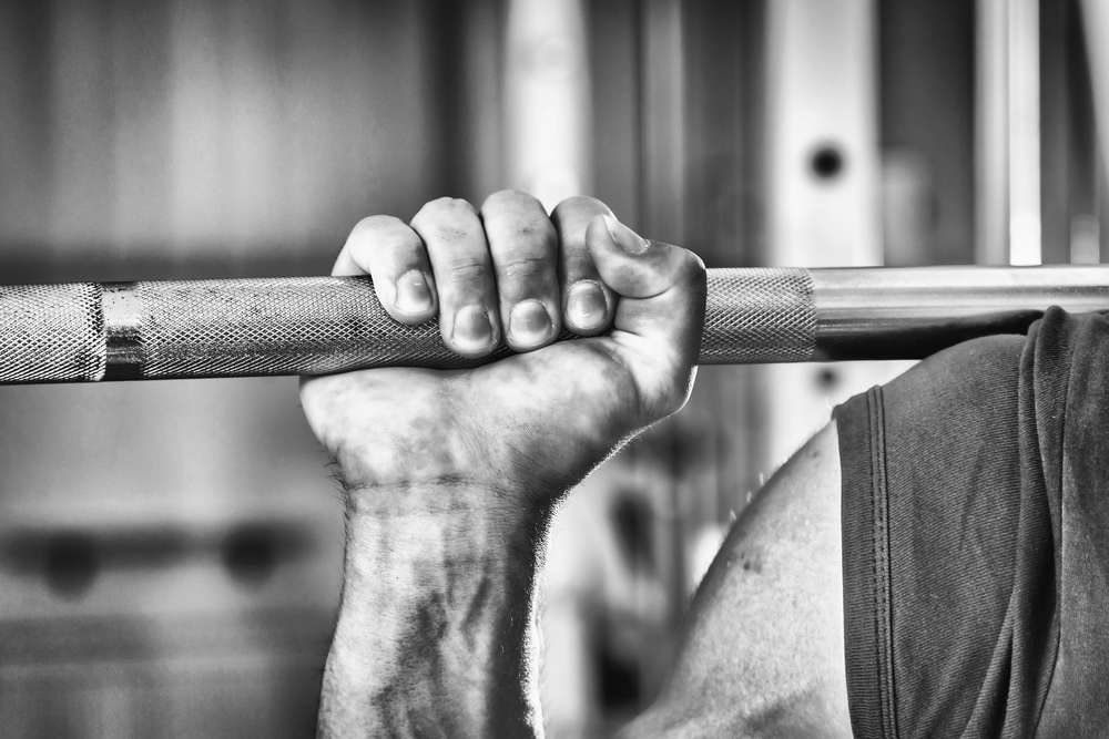 saying a prayer before a barbell workout