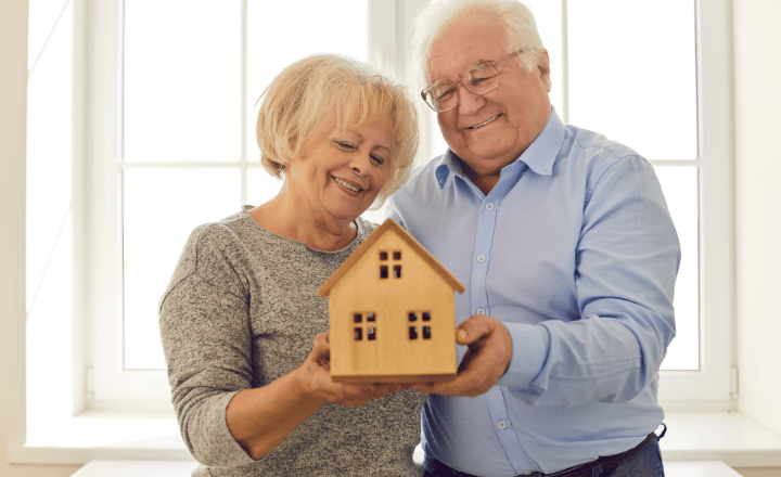 happy elderly couple in their new home