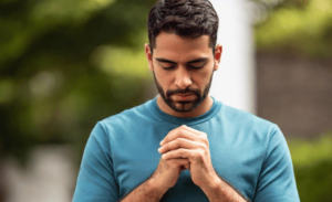 a man praying for a miracle to happen